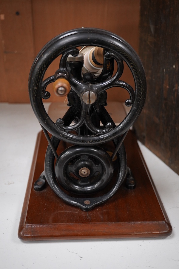 A late 19th century Willcox & Gibbs Automatic Silent Sewing Machine, with its instruction booklet and pine case. Condition - good.